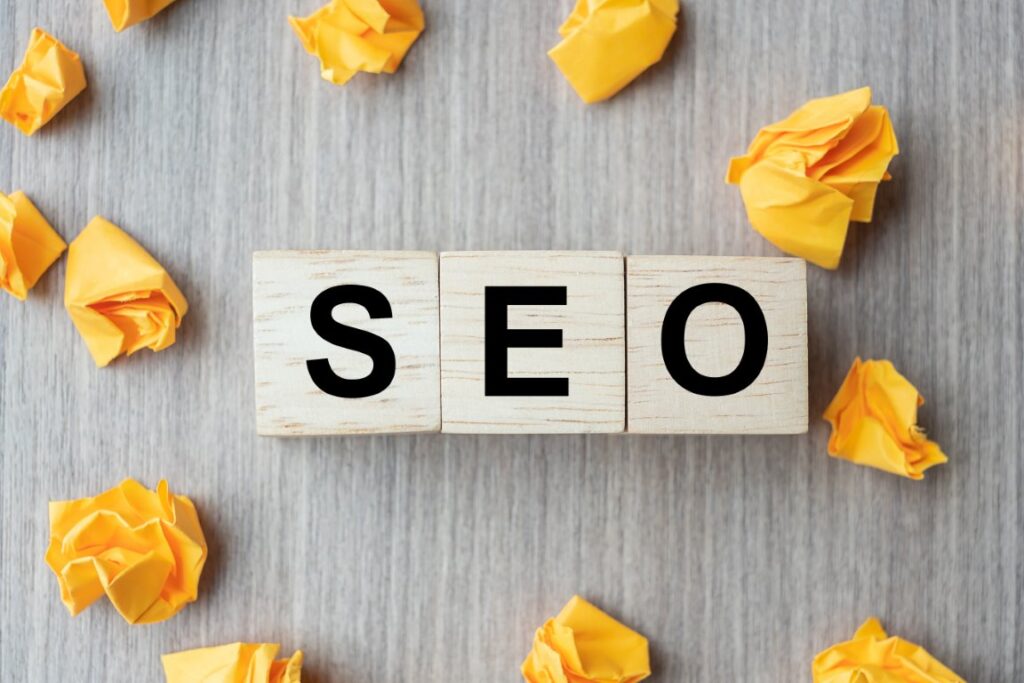 SEO (Search Engine Optimization) text wood cubes with crumbled p