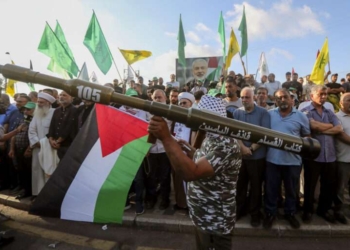 A supporter of the Lebanese Islamic group and the Islamist Hamas movement holds a mock rocket as he attends with other supporters a protest to condemn the killing of Hamas political chief Ismail Haniyeh, Wednesday, July 31, 2024, in the southern port city of Sidon, Lebanon. Two back-to-back strikes in Beirut and Tehran, both attributed to Israel and targeting high-ranking figures in Hezbollah and Hamas, have left Hezbollah and Iran in a quandary. (AP Photo/Mohammed Zaatari)
