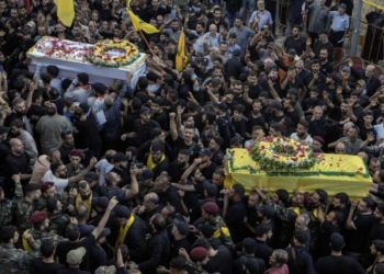 Mourners carry the coffins of victims who were killed Tuesday after their handheld pagers exploded, during their funeral procession in the southern suburb of Beirut, Lebanon, Wednesday, Sept. 18, 2024. (AP Photo/Bilal Hussein)