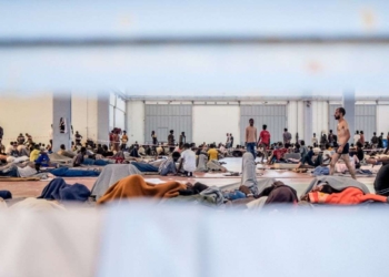 Πρόσφυγες και μετανάστες στο Εκθεσιακό Κέντρο Αγυιάς Χανιών, Δευτέρα 15 Σεπτεμβρίου 2025. Συνολικά στο χώρο φιλοξενούνται περισσσότερα απο 1.100 άτομα, προερχόμενα από διαφορετικά περιστατικά διάσωσης σε θαλάσσιες περιοχές της Κρήτης. Ο αριθμός αυτός ξεπερνά κάθε δυνατότητα υποδομής του χώρου, που έχει μετατραπεί σε σημείο έκτακτης φιλοξενίας χωρίς τις στοιχειώδεις προϋποθέσεις. Η εικόνα είναι εκρηκτική, άνθρωποι που παραμένουν εγκλωβισμένοι για εβδομάδες, χωρίς προοπτική και με τις αντοχές τους εξαντλημένες. Σύμφωνα με τον προγραμματισμό, αναμένονταν η αναχώρηση περίπου 400 μεταναστών για την ηπειρωτική χώρα, ανάμεσά τους και 340 άτομα που έχουν ήδη συμπληρώσει πάνω από έναν μήνα στον χώρο. Η καθημερινότητα στον χώρο χαρακτηρίζεται από εντάσεις, με τους ανθρώπους να διαμαρτύρονται για τις άθλιες συνθήκες διαβίωσης. Η παρατεταμένη παραμονή, χωρίς σαφή εικόνα για το μέλλον τους, έχει δημιουργήσει μια ατμόσφαιρα ασφυξίας και οργής. 
(EUROKINISSI)